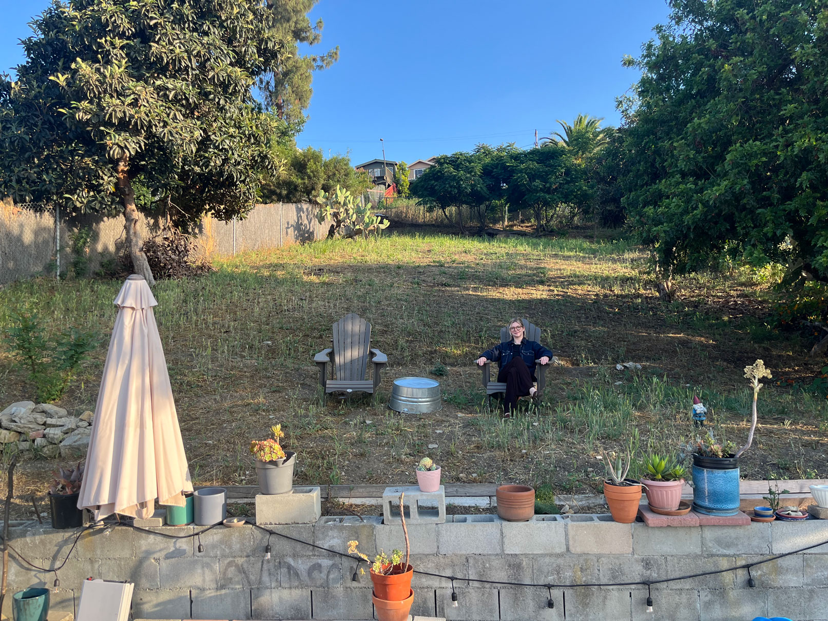 Photo of copywriter Cassiel Archdeacon wearing a blue shirt with black pants.